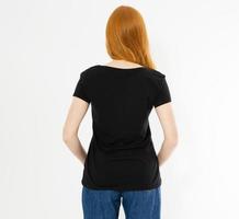 back view t-shirt design, happy people concept - smiling red hair woman in blank black t-shirt pointing her fingers at herself, red head girl tshirt mock up photo