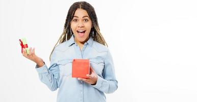 Beautiful sexy young woman holds a small open gift box isolated - Copy space photo