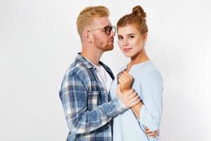 Portrait of a beautiful young happy smiling elegant couple - isolated mock up, background people.B eautiful young happy couple love smiling embracing, man and woman smile looking at camera photo