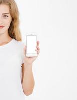 cropped portrait woman hold blank screen cell phone isolated on white background. Arm holding smartphone, copy space photo