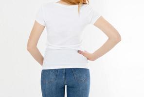 white t-shirt on a smiling girl back view. Red hair woman with empty tshirt mock up photo