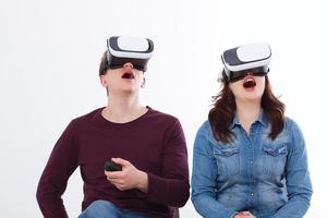 Young man and woman in casual clothes in virtual goggles, vr isolated on white background. Technology and innovation concept. Copy space and mock up. Template photo