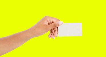 afro american hand showing paper card isolated on yellow background, arm hold businesscard