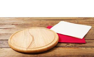 empty food pizza board and napkins on table isolated on white background copy space photo