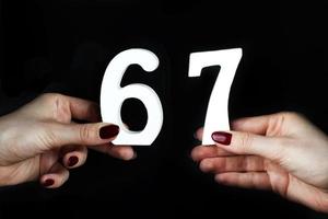 To female hands the number sixty-seven. photo