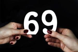 To female hands the number sixty-nine. photo