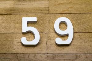 Figures fifty-nine on a wooden, parquet floor. photo