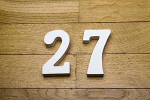 Figure twenty-seven on a wooden, parquet floor. photo