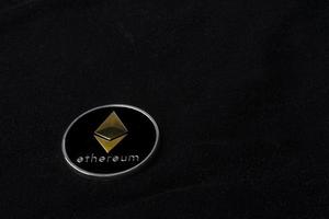 Ethereum coin on black background photo