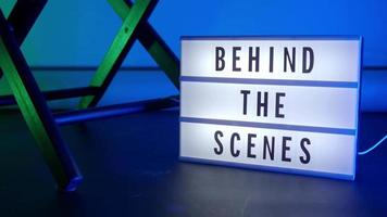 Behind the scene letters on cinema light box. Black text on white LED lightbox video