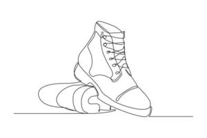 Continuous line drawing of man work boots. Single one line art of safety hiking boots. Vector illustration