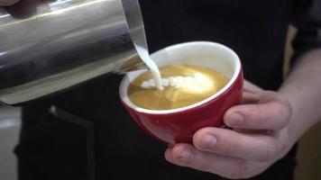 barman bereidt kopje koffie cappuccino met melk in een café-bar
