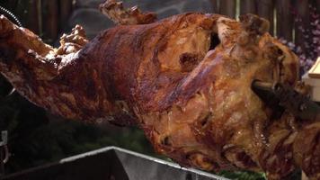 The Calf roasting on a Spit covered with a Crispy golden brown video