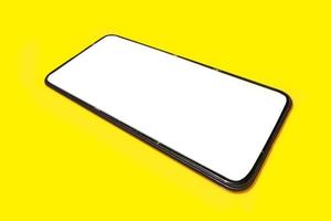 Smart phone on yellow background. photo