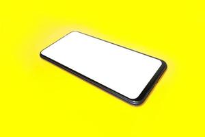 Smart phone on yellow background. photo