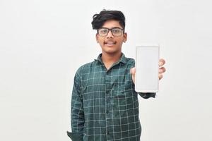 Young indian man showing smartphone screen on white background. photo