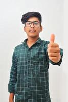 Young indian man showing thump up. photo