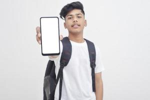 Indian college student showing mobile screen on white background. photo