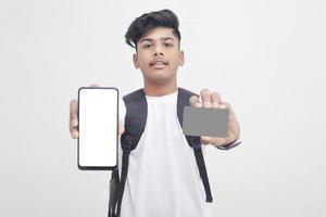 Indian college student showing mobile screen and card on white background. photo