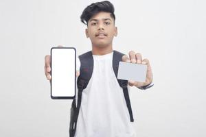 Indian college student showing mobile screen and card on white background. photo