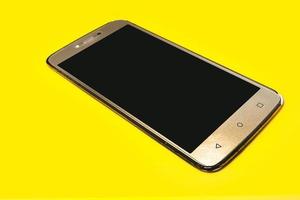 Smart phone on yellow background. photo