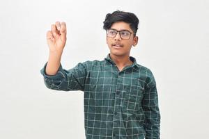 Young indian man wearing glasses and writing photo