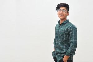 Young indian man standing on white background. photo