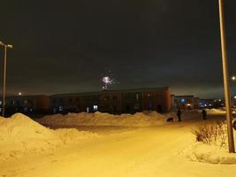 New Year's fireworks in the cottage village on a winter night photo