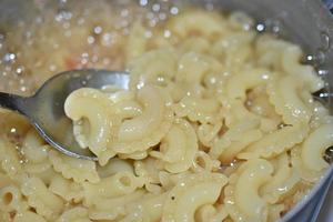 Cooking pasta in a pot in the kitchen photo