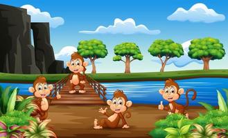 dibujos animados de monos pasando el rato en el puente de madera vector