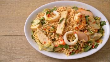 Instant noodle spicy salad with mixed meats - Asian food style