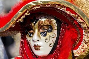 Venice, Italy, February 10, 2013 - Unidentified person with Venetian carnival mask in Venice, Italy. At 2013 it is held from January 26th to February 12th photo