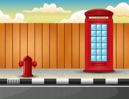 Red telephone box on the roadside vector