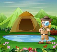 The explorer boy with a magnifying glass in nature vector