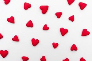 Red hearts on a white background top view. Valentines Day minimalistic pattern photo