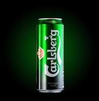 Almaty, Kazakhstan  October 11, 2019 can of beer Carlsberg in a green background with illumination. Advertising a brand of beer