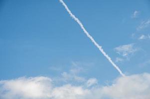 The plane's wake across the sky is like a cloud photo