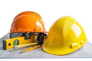 Safety first hard helmet hat and engineer tool on white background, engineering construction and architecture concept.