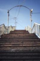 Old abandoned bridge over the railway. Old pedestrian bridge. photo