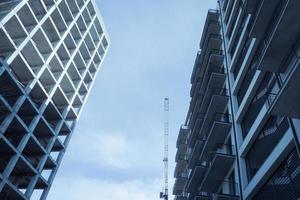 Modern multistory buildings under construction. Unfinished residential buildings. photo