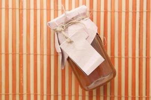 fresh honey in a glass jar with a paper empty label photo