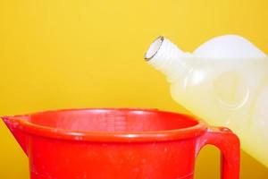 floor cleaning disinfect bottle against yellow background photo