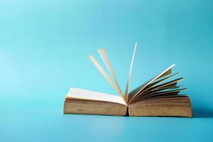 open book and a pencil on wooden table photo