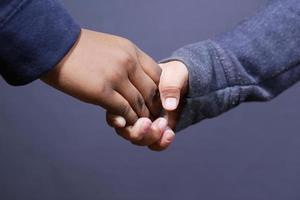 f child girl holding hand of her bother photo