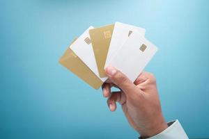 close up of person hand holding many credit cards photo