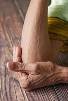 senior women suffering pain on elbow photo