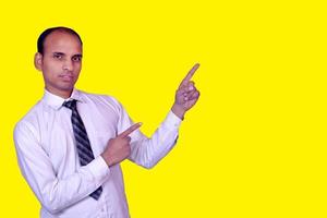 Young smiling Indian businessman pointing with finger upward image photo