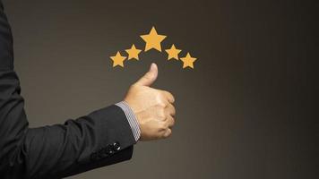 The businessman gave a thumbs up for his satisfaction rating. Service rating up to 5 stars, service, good response.