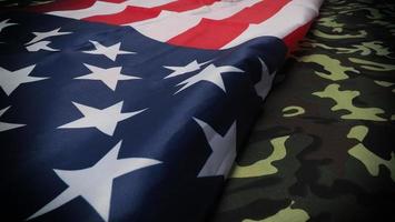 American flag and Military camouflage pattern. Top view angle. photo