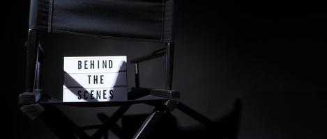 Director chair with behind the scene banner light box. photo